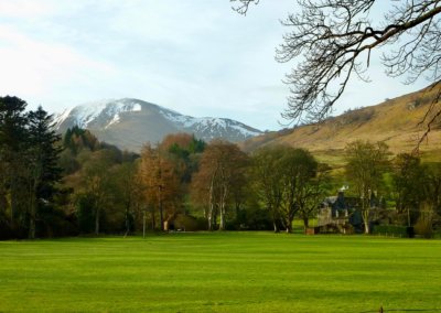 Scottish manor house with mountain in the background