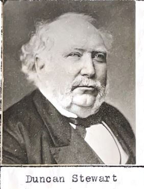 black and studio white head shot of a round-headed elderly man wearing a tuxedo jacket and bow tie. He has white bushy hair on the sides of his head and bald on top, with bushy eyebrows and a moustache down to his jaw. Photo taken in the 1890s.