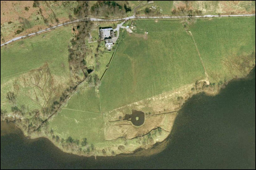 satellite view of a farm by a lake