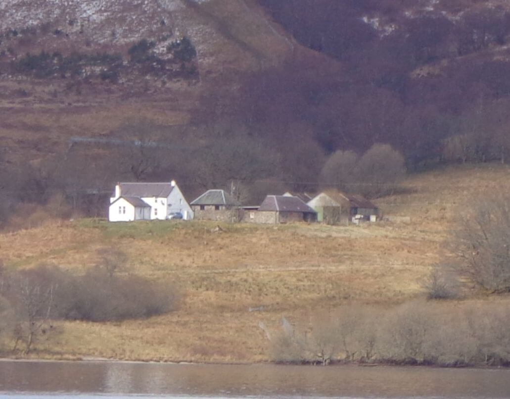 view of a Scottish farm estate viewed from a loch